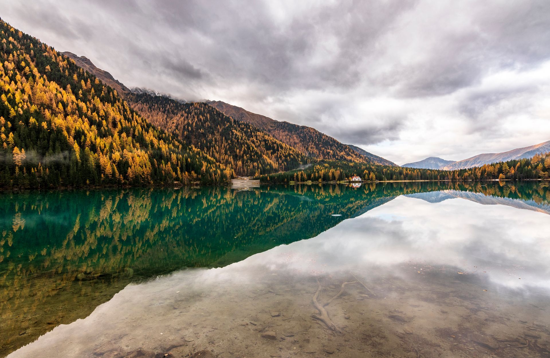 Golden autumn and beautiful reflections in the Anterselva lake. Alto Adige, Itlay. Excellent destination for family excursions too.