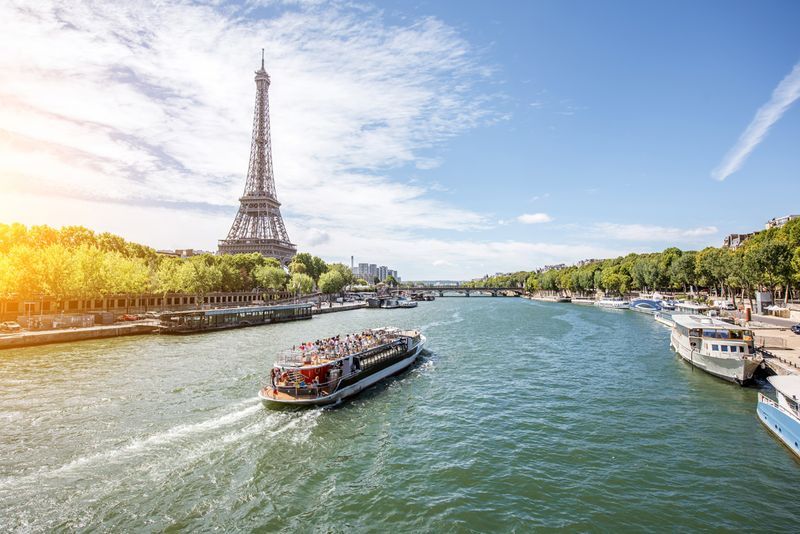 Landscpae view on the Eiffel tower and Seine river with tourist boat in Paris