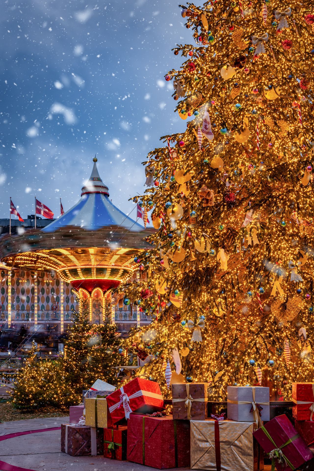 Christmas in Copenhagen, Tivoli Gardens, with a decorated tree, in front of a spinning Carousel, snowfall and bokeh lights, Denmark